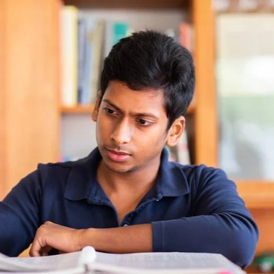 depositphotos_430527070-stock-photo-handsome-indian-student-studying-university