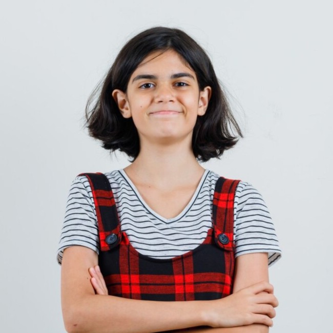 preteen-girl-standing-with-crossed-arms-t-shirt-jumpsuit-looking-hopeful-front-view-space-text_176474-57491